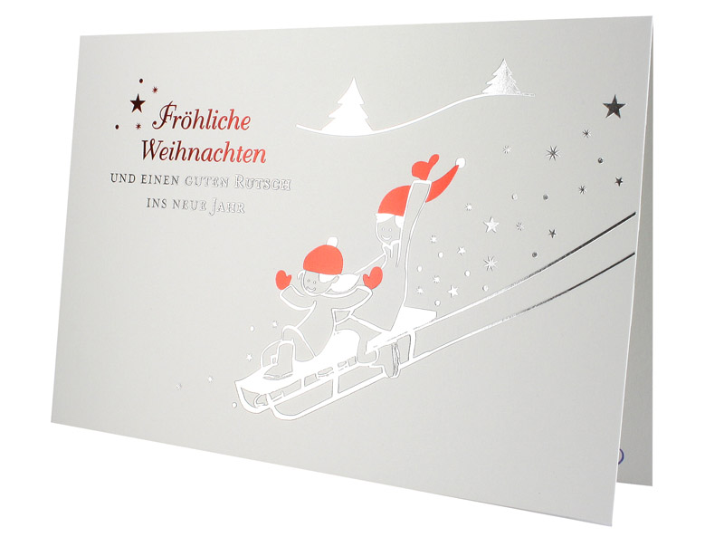 Lustige Weihnachtskarten mit Spende zugunsten Deutsche Krebsgesellschaft mit fröhlichen Kindern bei der Schlittenfahrt und Weihnachtsgruß