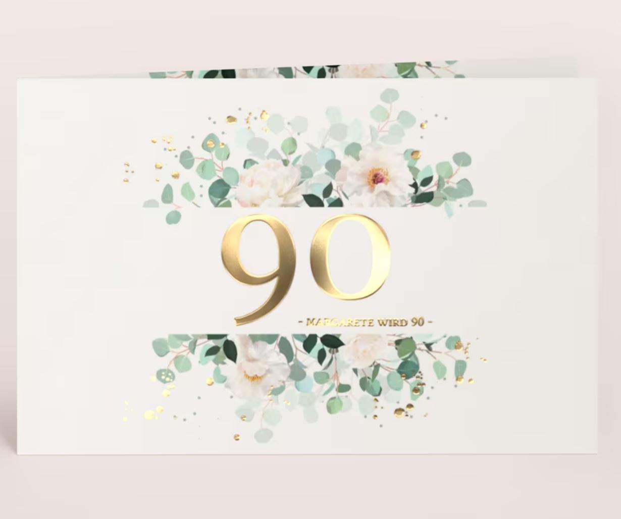 Jubiläumseinladung zum Geburtstag als Klappkarte mit floralem Druck und edler Goldfolienprägung der Jubiläumszahl 90 als Beispiel.