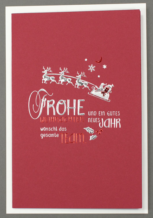 Weihnachtskarte in rot mit Silber- und Rotfolienprägung mit Weihnachtsgrüßen vom gesamten Team